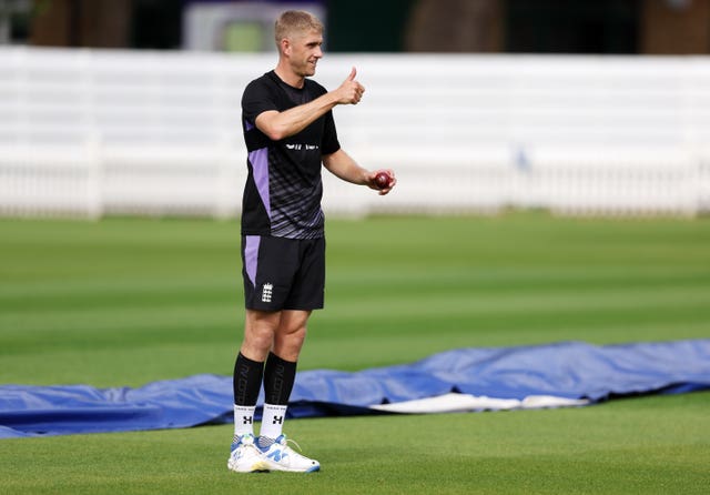 Olly Stone puts his right thumb up during an England training session 