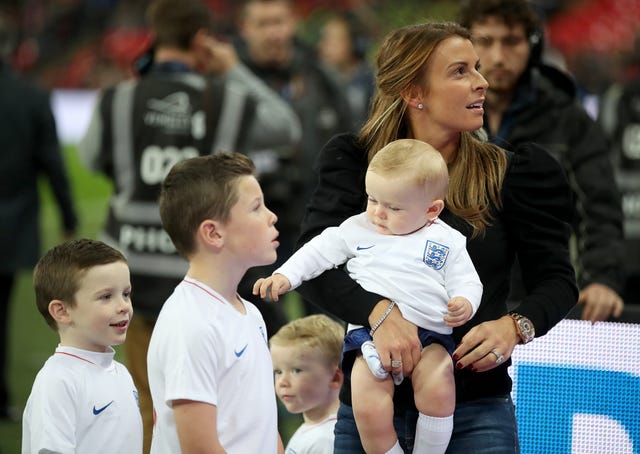 Rooney's wife, Coleen , and children on the pitch before kick-off 