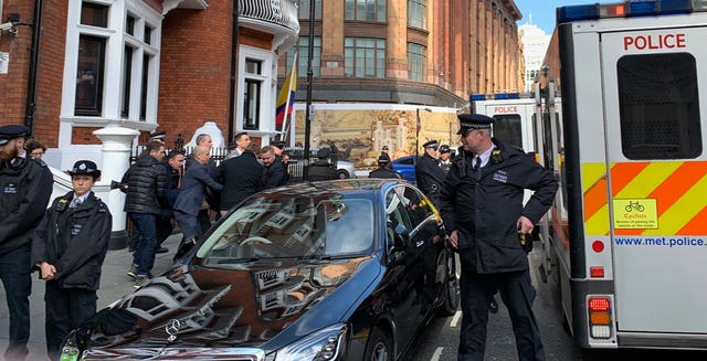 Police carry WikiLeaks founder Julian Assange from the Ecuadorian embassy after he was arrested by officers from the Metropolitan Police