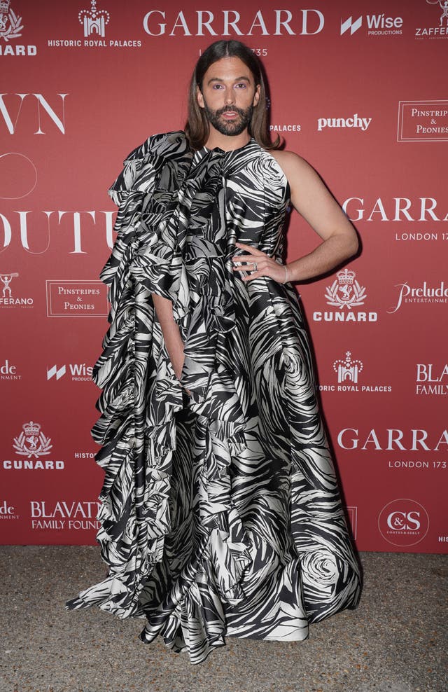 Jonathan Van Ness wearing a flowing black and white gown at a red carpet event
