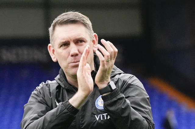 Manager Dave Challinor applauds the fans after Stockport's promotion-clinching win over Morecambe