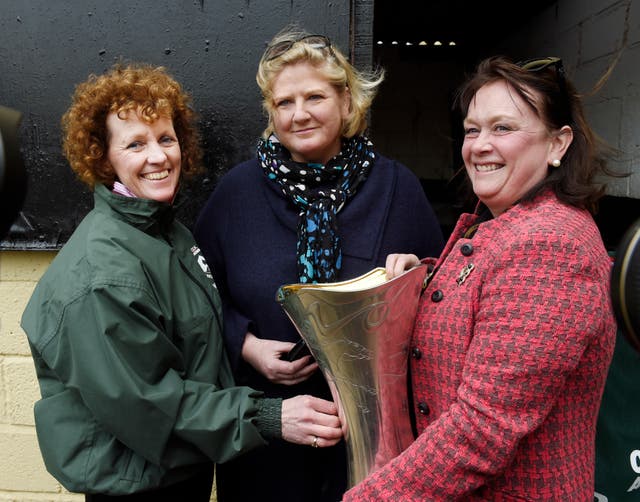 One For Arthur’s owners Belinda McClung (centre) and Deborah Thomson with trainer Lucinda Russell (left) with the trophy