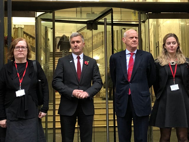 Dr Richard Freeman (second left) stands with his defence team outside the building in Manchester where the long-running hearing is taking place