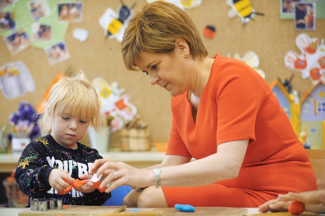 Nicola Sturgeon with a child at a nursery