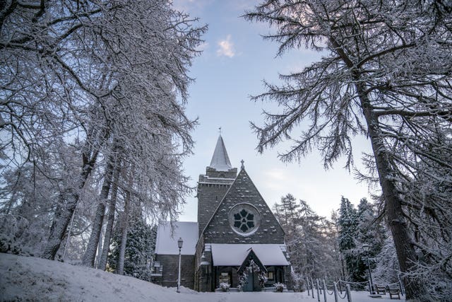 A church in a forest covered in snow