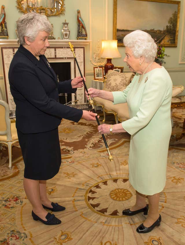 The Queen presents Sarah Clarke with her Black Rod (Dominic Lipinski/PA)