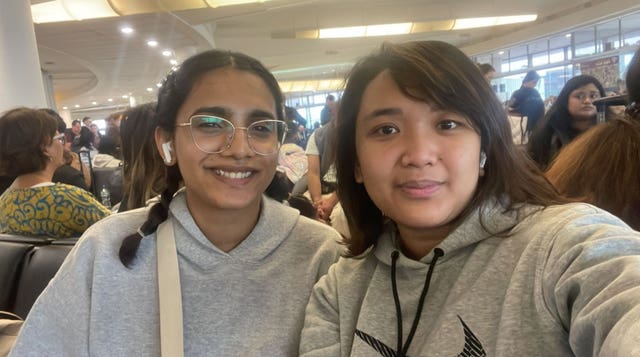 Farah Rafeeq, left, and Niken Wulan await their replacement flight at Gatwick