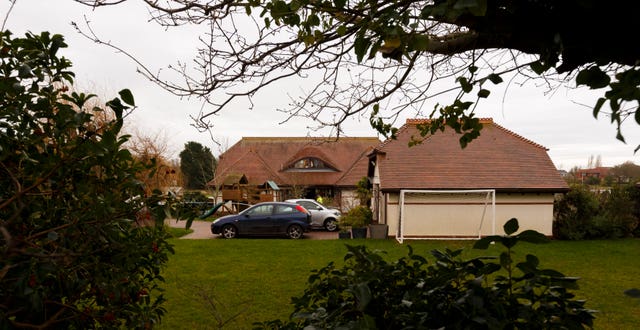 Police at the house in Bosham, West Sussex, where Valerie Graves was found bludgeoned to death