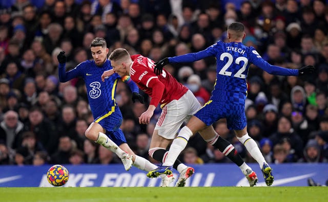 Scott McTominay battles for the ball with Jorginho