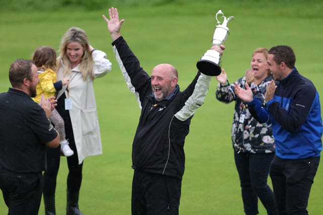 Lowry’s father Brendan lifts the trophy aloft