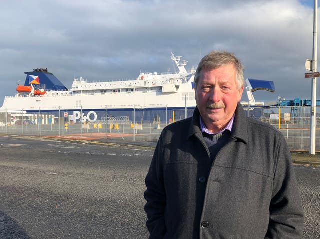 East Antrim MP Sammy Wilson in front of P&O European Causeway ferry docked at Larne Port 