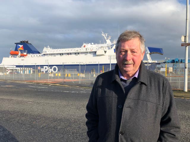 East Antrim MP Sammy Wilson in front of P&O European Causeway ferry docked at Larne Port