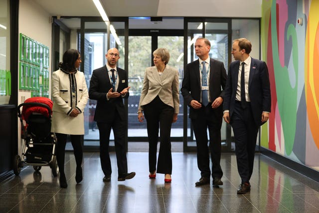 Theresa May is joined by Matt Hancock and local health officials