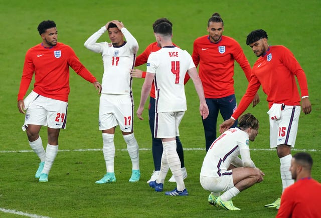 Jason Sancho is consoled by England team-mates