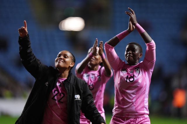 South Africa’s Sibulele Holweni, right, and Amogelang Motau enjoy the post-match atmosphere in front of their fans