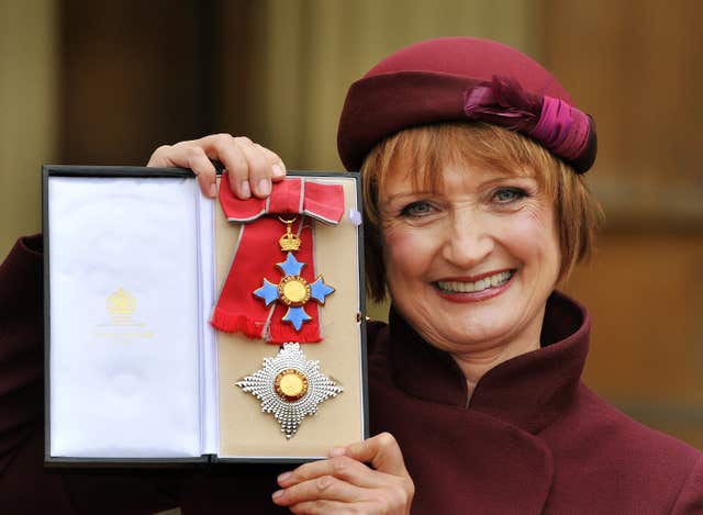 Dame Tessa Jowell proudly holding her Dame Commander insignia, after it was presented to her by the Prince of Wales in 2013 (John Stillwell/PA)