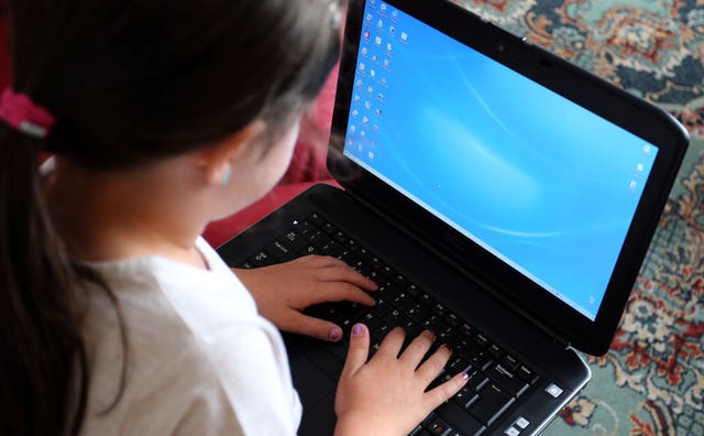 A child uses a laptop