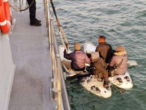Migrants who attempted to cross the English Channel on a makeshift raft made from two windsurfing boards