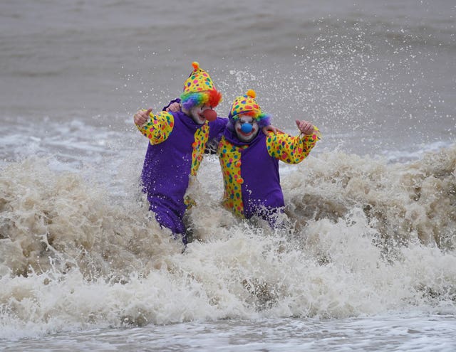 Swimmers Perry Springate and Chris Johnson dressed as clowns for their Christmas dip
