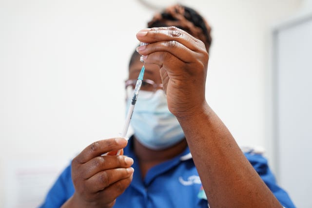 A nurse prepares a dose of a Covid-19 vaccine