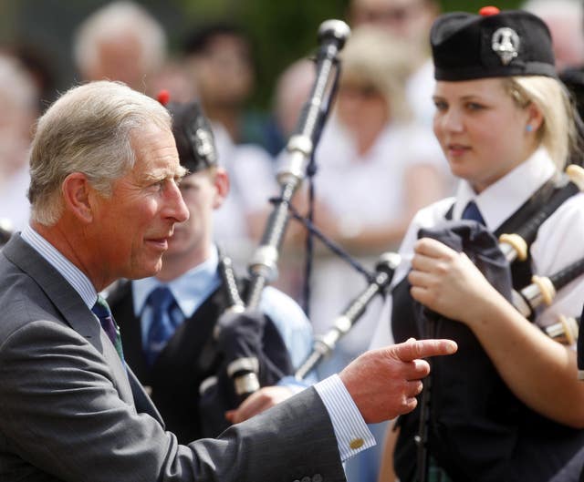 Prince Charles chats with members of the National Youth Pipe Band outside the National Piping Centre in Glasgow (Danny Lawson/PA)