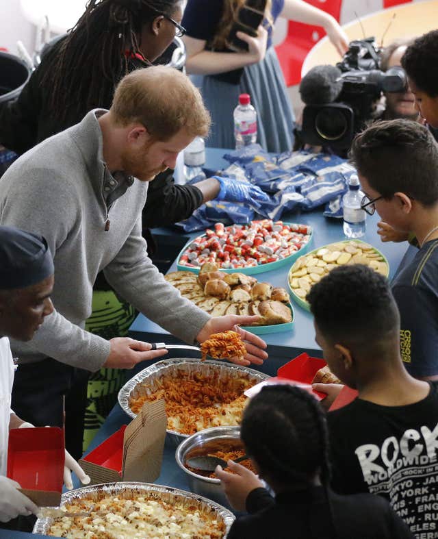 Harry enjoyed dishing out food to the youngsters from Roundwood Youth Centre as part of the Fit and Fed Campaign (Frank Augstein/PA Wire)