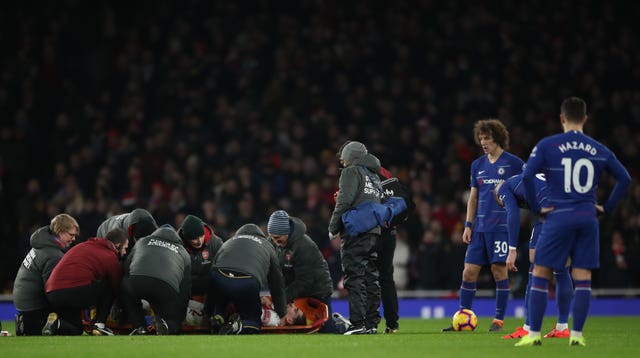 Bellerin is tended to by medical staff after suffering a knee injury against Chelsea in January of this year