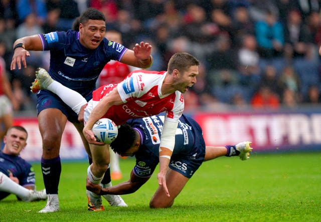 Hull KR's Matt Parcell is tackled by Kai Pearce-Paul as Wigan booked their place in the Super League Grand Final with a 42-12 win at Headingley 
