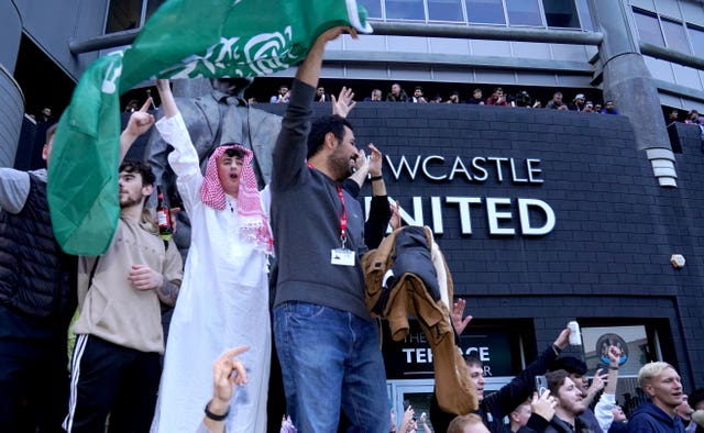 Newcastle United fans celebrate at St James’ Park following the announcement that the Saudi-led takeover of Newcastle had been approved