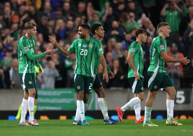 Northern Ireland players celebrate the third goal scored at Windsor Park