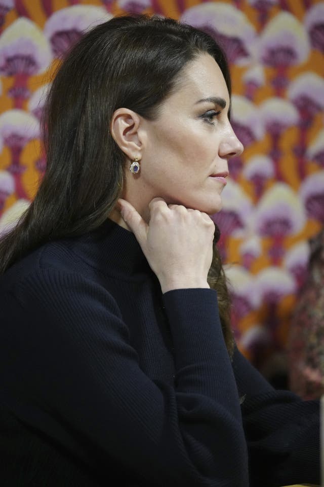 Kate listens to staff during a visit to the Open Door mental health charity