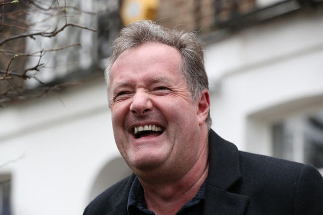 Piers Morgan laughs as he speaks to reporters outside his home in Kensington, central London