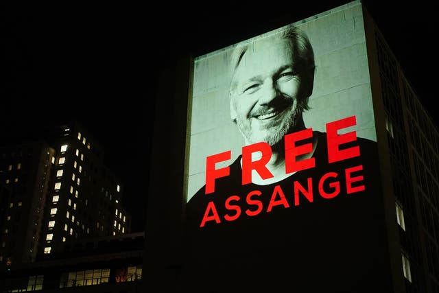 Image of Julian Assange projected onto a building in Leake Street in central London