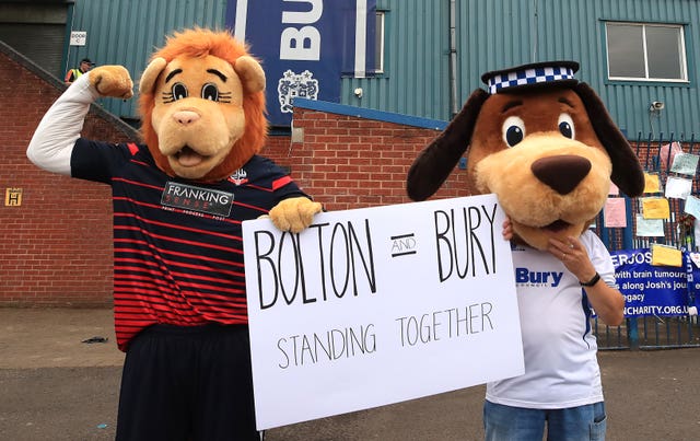 Bolton mascot Lofty the Lion (left) and Bury mascot Robbie the Bobby at Gigg Lane, Bury (Peter Byrne/PA)