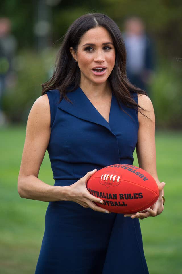 The Duchess picked up an Australian rules football while watching a demonstration of sporting activities organised by the This Girl Can campaign
