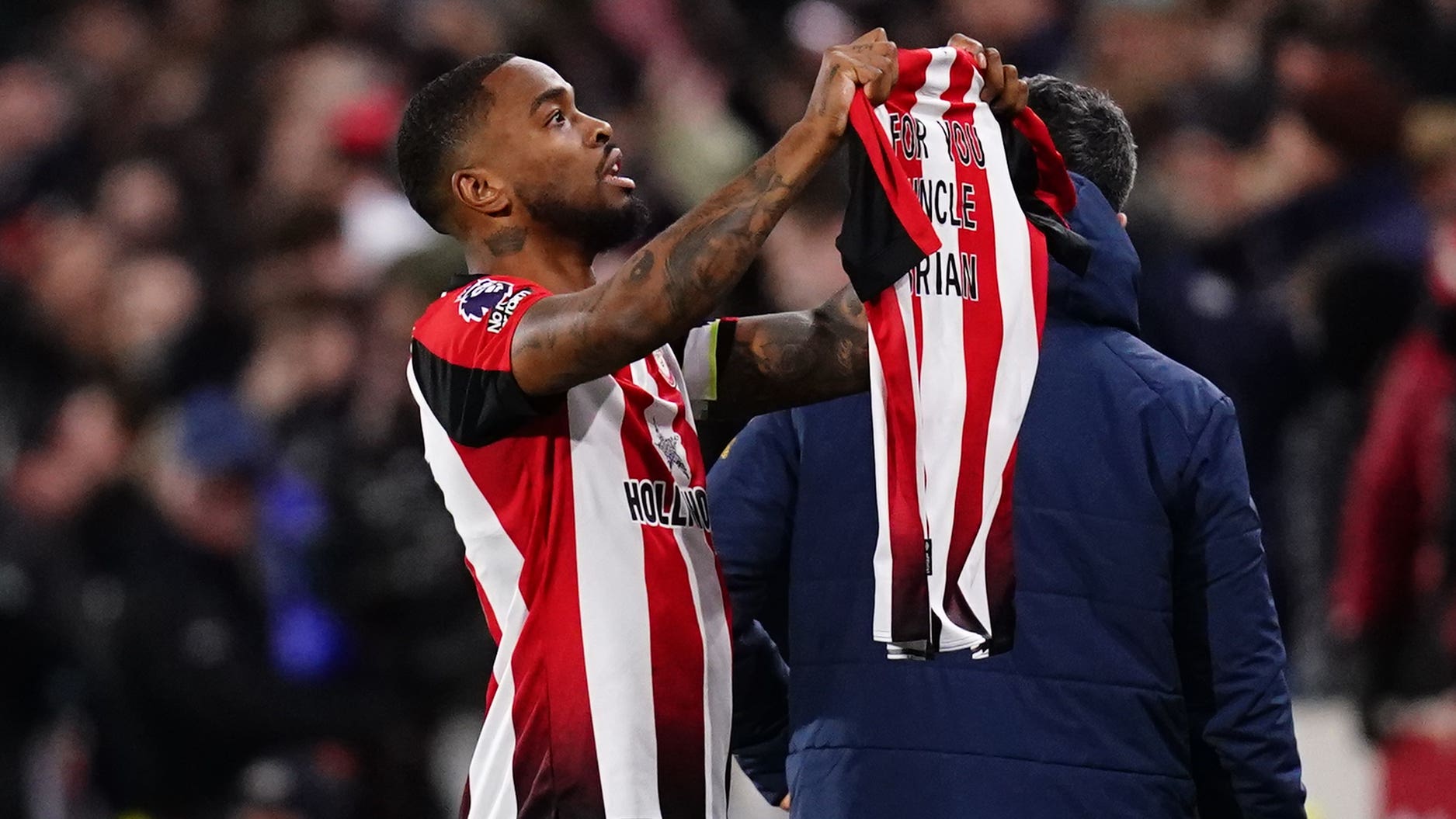 Brentford’s Ivan Toney celebrates scoring their side’s first goal of the game, and holds up a shirt dedicated to his uncle Brian during the Premier League match at the Gtech Community Stadium, London. Picture date: Saturday January 20, 2024.