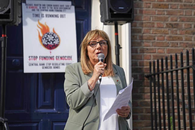 Frances Black speaking into a mic during a protest