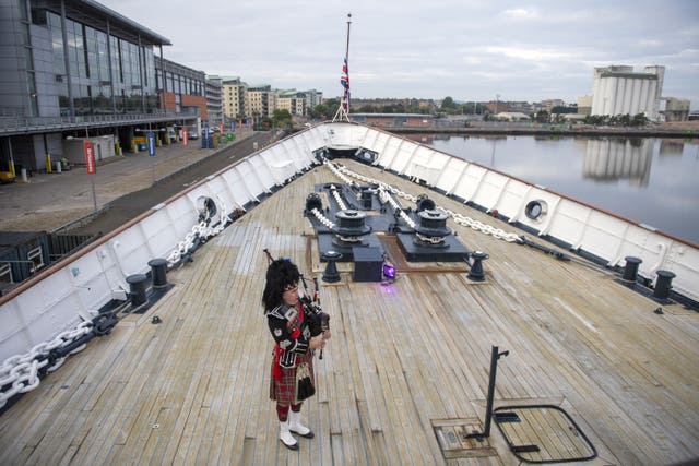 A piper plays a lament aboard the Royal Yacht Britannia, moored in Leith, Edinburgh, ahead of the Queen's funeral