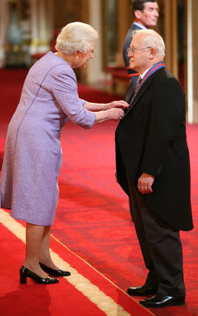 Oleg Gordievsky receives the Companion of the Most Distinguished Order of St Michael and Saint George from Queen Elizabeth II at Buckingham Palace. 