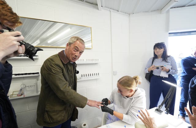 Nigel Farage has a nail painted at On The Lash beauty salon, in Hoyland, Barnsley, South Yorkshire, whilst on the General Election campaign trail 