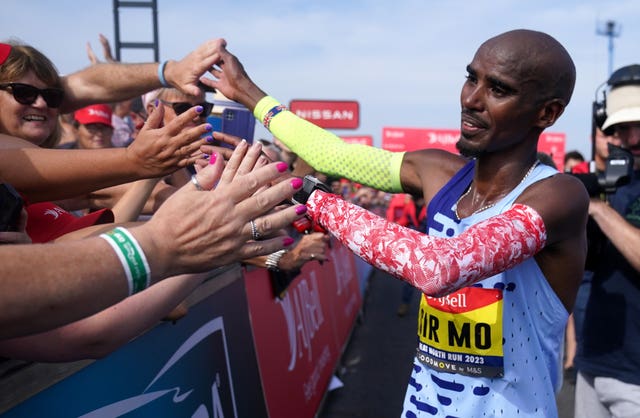 Farah greets fans after completing the Great North Run in the final race of the four-time Olympic champion's career (Owen Humphreys/PA)