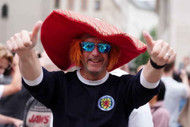 A Scotland fan wearing an oversized red hat