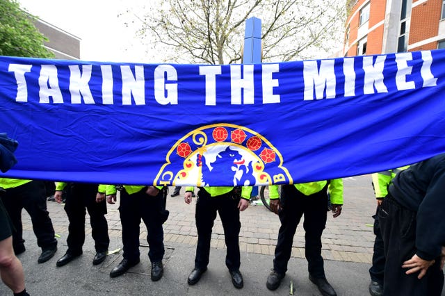 Chelsea fans refer to their former midfielder John Obi Mikel during their protest 