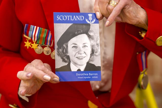 Dorothea Barron, 100, holds a picture of herself taken in 1943 