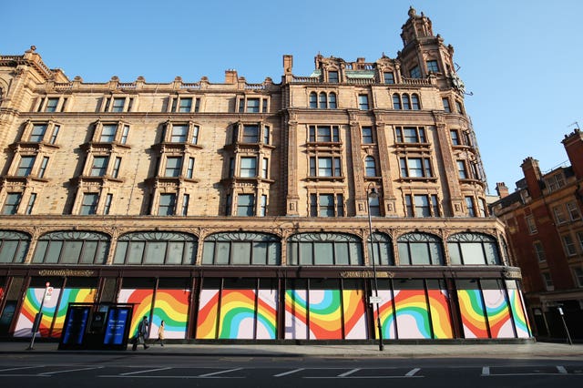 Rainbow displays adorn the windows of Harrods department store