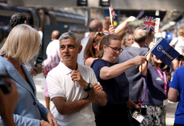 Mayor of London Sadiq at St Pancras International with supporters waving flags