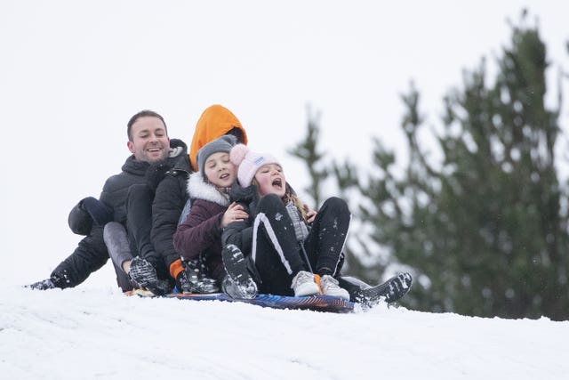 Left to right, Michael McInally, Katie Black, Rhea Black, 10, and Carmyn McInally, 10, sledging at Glencourse Golf Course near Penicuik, Midlothian