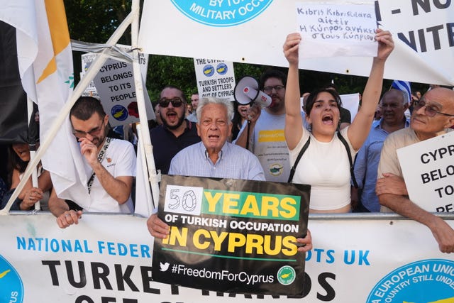 Protesters holding placards