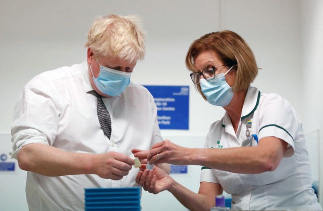 Prime Minister Boris Johnson Boris Johnson with advanced pharmacy technician Jane Hosea, during a visit to a vaccination centre in Northamptonshire