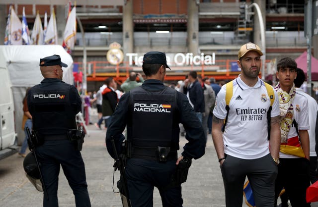 Police keep an eye on supporters outside the Bernabeu before last season's Champions League quarter-final between Real Madrid and Chelsea